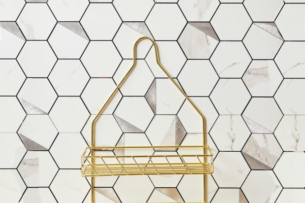 Honeycomb bathroom tile with golden shower cabby